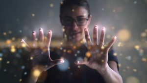 woman with her hands out looking at a futuristic technology with dots